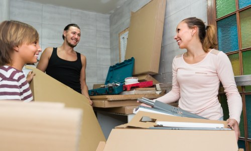 Professional packers carefully packing household items