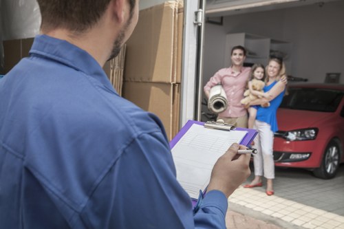 Packers preparing boxes in a small apartment