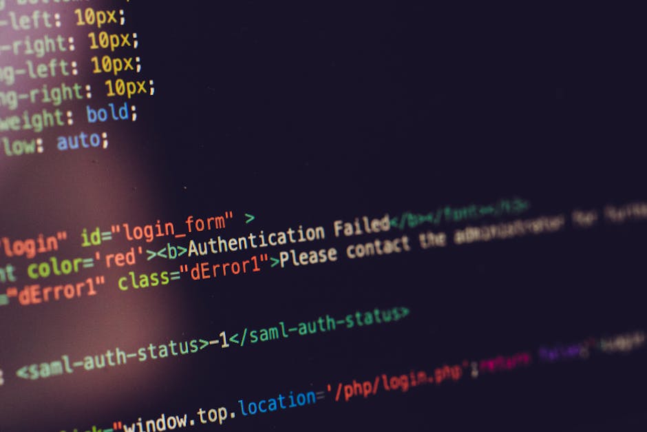 A close-up photograph of a computer screen displaying its source code with multicolored text on a black background, including snippets of HTML and error messages such as 'Authentication Failed' in red